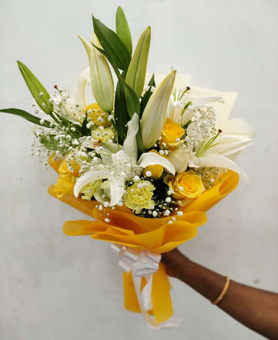 3 White Lilies 5 Yellow Carnation 10 White Roses 5 Yellow Roses Bunch With Paper Packing
