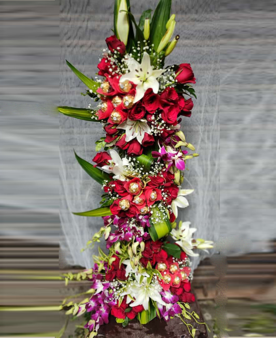 White Lilies Red Roses Orchids With Ferrero Rocher 3 Feet Tall Arrangement